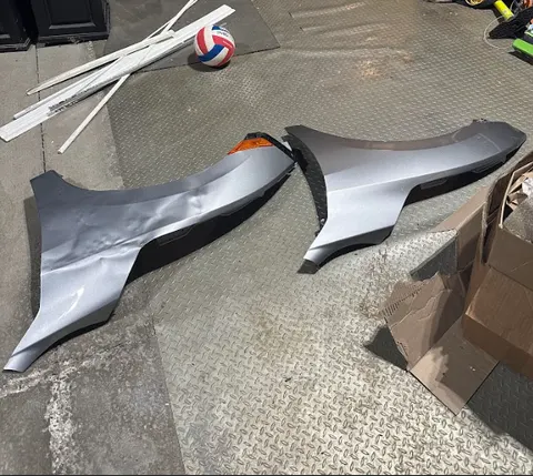 Repaired fender with colour-matched finish