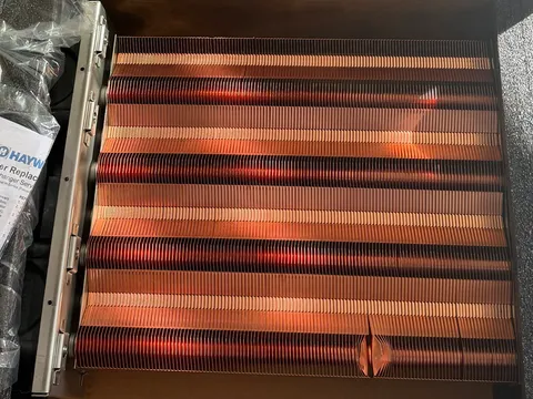 New copper heat exchanger in its box before installation